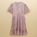 Front view of pink floral short sleeve tiered mini dress, lightweight fabric with a multicolour ditsy print, relaxed fit silhouette, neutral studio background.