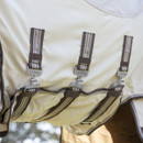 Close-up of a beige horse blanket with brown striped straps and metal buckles. The brand "LeMieux" is engraved on buckles, suggesting high quality.
