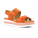 Angled front view of an orange platform sandal showing cross straps, round buckle detail and ridged chunky sole.