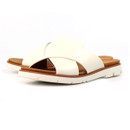 Pair of white crossover strap mule sandals on a white background, angled to show the tan footbeds and chunky white soles.
