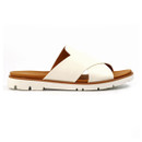 Profile view of white crossover strap mule sandal on a white background, highlighting the open toe and tan cushioned insole.