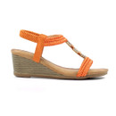 Profile view of orange braided wedge sandals on a white background, highlighting the textured wedge heel and tan footbed.