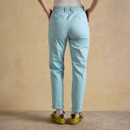 Back view of light blue straight-leg chinos showing elasticated waistband and back pockets.