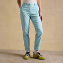 Model wearing light blue straight-leg chinos with rolled cuffs, front view on neutral studio backdrop.