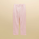 Flat lay of pale pink women’s chinos showing straight leg cut, button waist and turned-up cuffs.