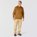 Full-length view of male model wearing a brown Carhartt hooded sweatshirt with beige cargo trousers and brown work boots.