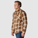 Side view of model wearing brown and cream plaid Carhartt long-sleeve shirt.