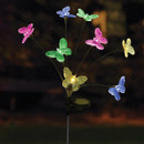 Solar-powered garden stake light with eight butterfly-shaped LEDs glowing in multiple colours, displayed outdoors at night