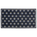 Dark blue rectangular mat with a pattern of small, white floral shapes and yellow dots. The rug has a simple white border, giving it a modern look.