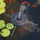 Floating solar pond fountain spraying water upward, surrounded by lily pads with orange fish swimming beneath the surface.