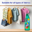 Clothes on hangers showcase various fabrics: floral tank, yellow shirt, denim, white and pink tops. Bold text reads "Suitable for all types of fabrics." A detergent bottle is in the foreground.