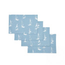 Set of four blue cotton placemats with white sailboat pattern displayed stacked on a white background, showing consistent coastal design and fabric texture.