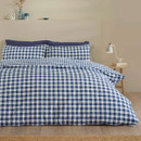 Reversible blue gingham duvet cover set shown with larger check pattern on the bed