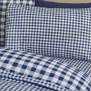 Close-up of blue gingham pillowcase with small check pattern and cotton fabric texture