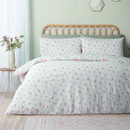 Reversible duvet cover set with scattered pink floral print on a soft white background