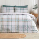 Green and white tartan duvet cover set styled on a bed with matching pillowcases, wooden bedside table and neutral bedroom décor.