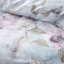 Detailed close-up of the duvet cover fabric showing soft blue floral prints and botanical leaf illustrations.