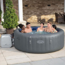 Group of adults relaxing together in a grey Lay-Z-Spa Santorini inflatable hot tub on a stone patio.