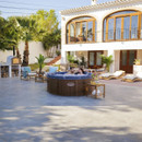 Lay-Z-Spa Toronto inflatable hot tub set in a spacious luxury garden with sun loungers and a villa backdrop.