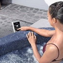Woman using the built-in digital control panel on a Lay-Z-Spa Toronto inflatable hot tub.