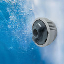 Close-up of an active Lay-Z-Spa hydrojet underwater, releasing pressurised water for massage.