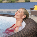 Woman reclining in a Lay-Z-Spa Bali inflatable hot tub with soothing water jets.