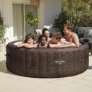 Family relaxing together in a Lay-Z-Spa Bali inflatable hot tub outdoors.