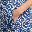 Detail view of women’s blue and white printed shift dress showing side pocket.