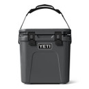 Charcoal gray YETI Roadie 24 hard cooler with carry handle, front view.