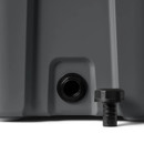 Close-up of the YETI Roadie 24 cooler drain port with drain plug removed beside it