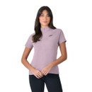 Woman wearing a mauve WeatherBeeta short sleeve riding top with half zip and black leggings on a white background.