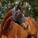 Side view of horse wearing a grey fly mask with mesh eye protection outdoors.