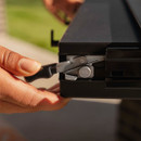 Close-up of Blackstone griddle side shelf locking mechanism being secured into place.