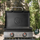 Front view of Blackstone 2-burner portable gas griddle with hood and stainless steel control panel, dual temperature dials and compact camping-ready design.
