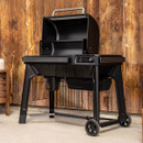 Traeger Woodridge wood fired pellet grill with lid open and warming rack