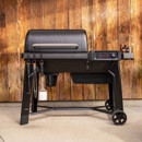 Traeger Woodridge pellet grill closed with grilling tools and side shelf