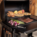 Traeger Woodridge pellet grill with side shelf and grilling tools attached