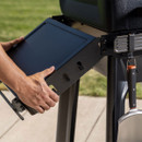 Folding side shelf being positioned and locked into place on Traeger Woodridge Pro grill.