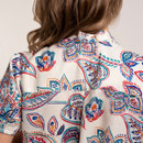 Back detail of the cream paisley print blouse showing gathered yoke and short sleeves.