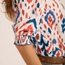 Close-up of the three-quarter length sleeve with elasticated cuff on the cream abstract print blouse.