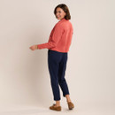 Back and side view of coral cropped jacket styled with navy trousers and tan suede loafers.