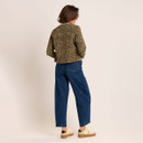 Back view of the cropped leopard print jacket styled with wide-leg blue jeans and cream trainers.
