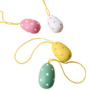 Close-up of pastel polka dot mini egg hanging decorations in pink, white, yellow and green with yellow loops, displayed against a plain white background.