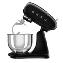 Black SMEG stand mixer fitted with dough hook attachment and stainless steel mixing bowl, side angle view on a white background.