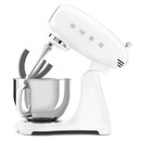 White Smeg stand mixer with flat beater attachment fitted above stainless steel mixing bowl.