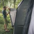 Man attaching side panel to Outwell awning tent outdoors