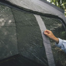 Close-up of hand fastening Outwell awning tent panel connection