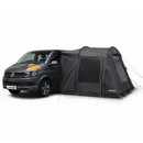 A dark grey van is parked with a large, grey awning attached to its side. The tent, branded Vango, has orange accents, conveying a sense of adventure.