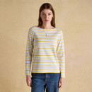 Woman wearing a long sleeve Breton top with yellow and light blue stripes, front view.