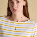 Close-up of yellow and light blue striped Breton top with gold necklace detail.